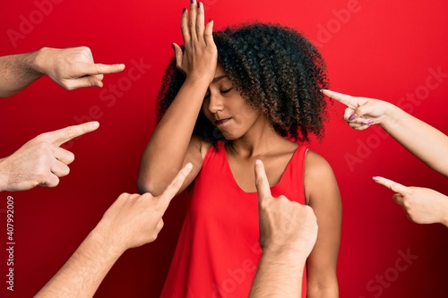 Beautiful african american woman with afro hair with fingers around pointing to herself surprised with hand on head for mistake, remember error. forgot, bad memory concept.