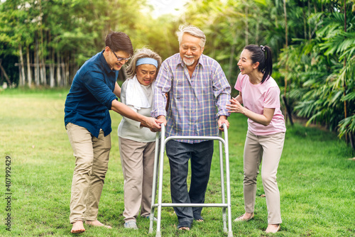 Portrait enjoy happy smiling love multi-generation asian big family.Senior mature father and elderly mother with young adult woman and son walking outdoor in park at home.insurance concept © Art_Photo