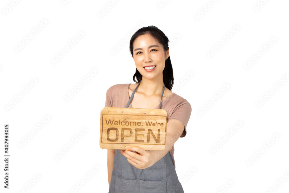 Beautiful young asian woman smiling pretty teeth wearing a apron.Woman holding a wooden sign pointing and thumbs up Beautiful young asian woman smiling pretty teeth wearing a apron.Woman holding a wooden sign pointing and thumbs up