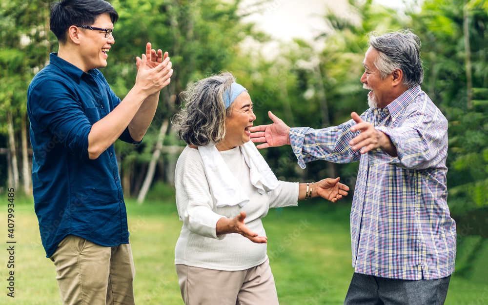 Portrait enjoy happy smiling love multi-generation asian big family.Senior mature father and elderly mother with young adult man talking and hug outdoor in park at home.insurance concept