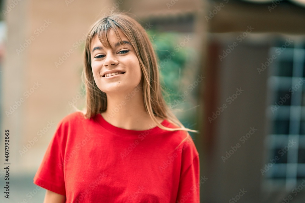 Caucasian teenager girl smiling happy standing at the city.