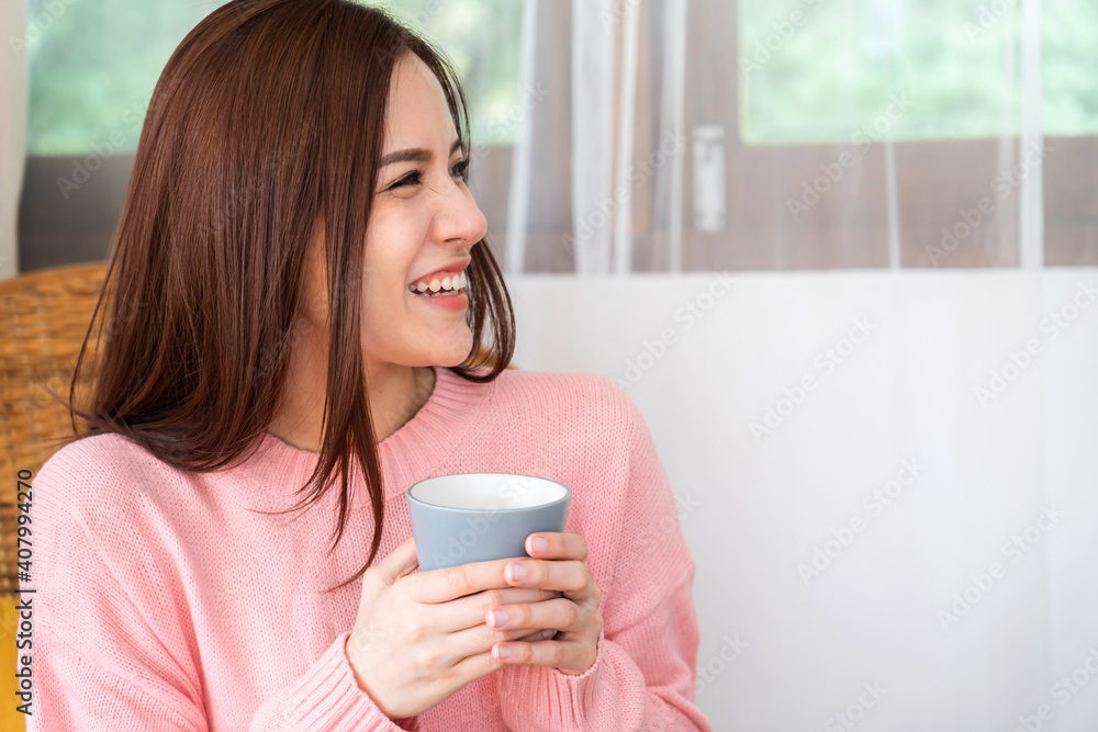 Portrait of smiling happy cheerful beautiful pretty asian woman relaxing drinking and looking at cup of hot coffee or tea.Girl felling enjoy having breakfast in holiday morning vacation on bed at home Portrait of smiling happy cheerful beautiful pretty asian woman relaxing drinking and looking at cup of hot coffee or tea.Girl felling enjoy having breakfast in holiday morning vacation on bed at home