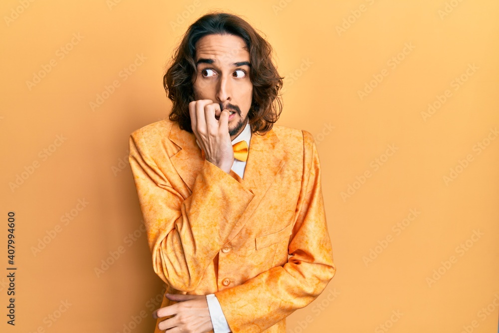Young hispanic man wearing hipster elegant look looking stressed and nervous with hands on mouth biting nails. anxiety problem. Young hispanic man wearing hipster elegant look looking stressed and nervous with hands on mouth biting nails. anxiety problem.