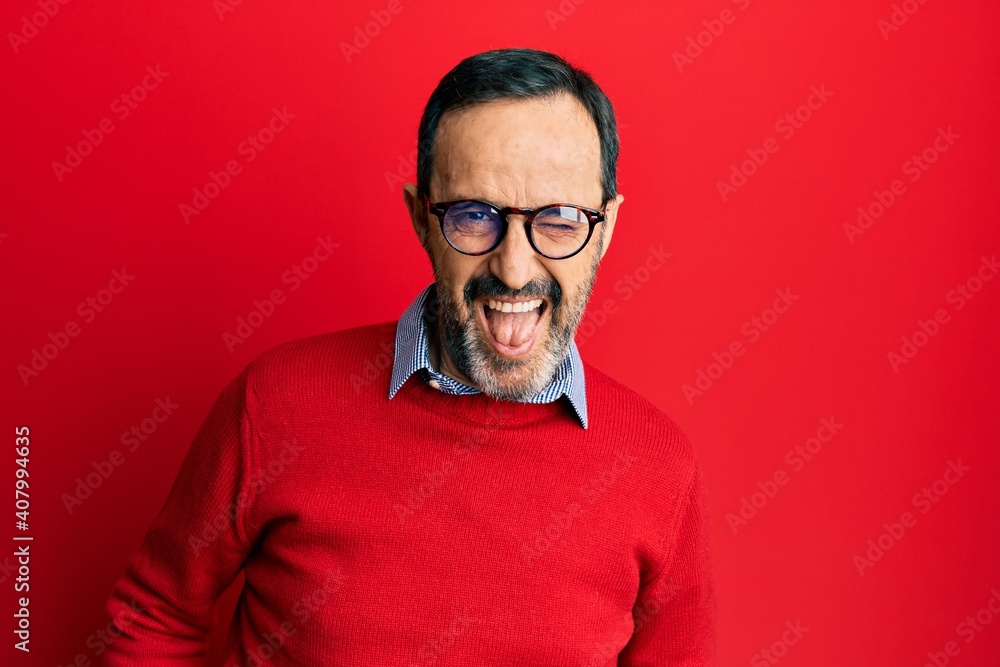 Middle age hispanic man wearing casual clothes and glasses winking looking at the camera with sexy expression, cheerful and happy face. Middle age hispanic man wearing casual clothes and glasses winking looking at the camera with sexy expression, cheerful and happy face.