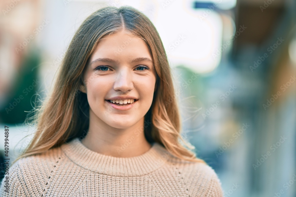 Fototapeta premium Beautiful caucasian teenager smiling happy standing at the city.