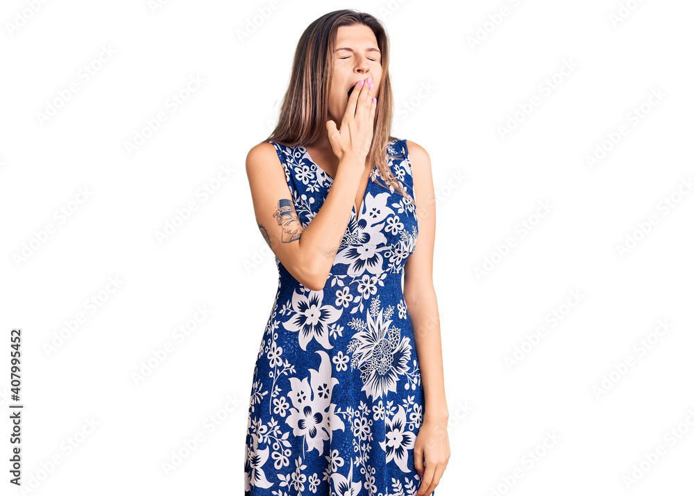 Beautiful caucasian woman wearing summer dress bored yawning tired covering mouth with hand. restless and sleepiness. Beautiful caucasian woman wearing summer dress bored yawning tired covering mouth with hand. restless and sleepiness.