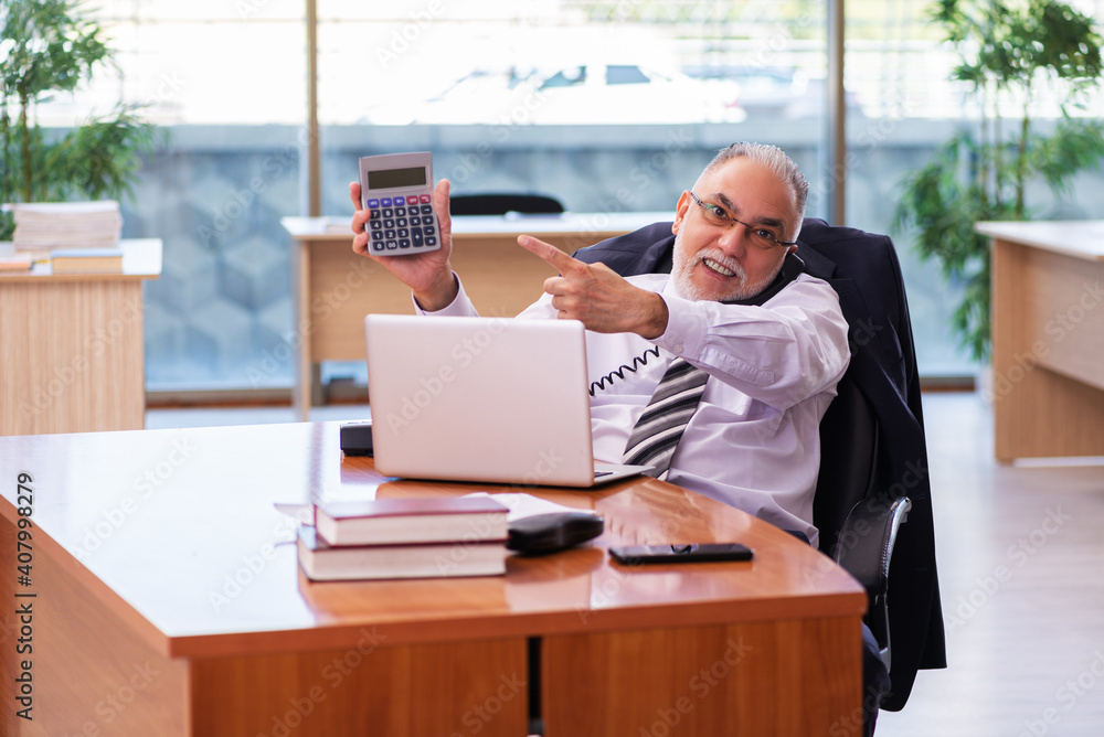 Old businessman employee working in the office Old businessman employee working in the office