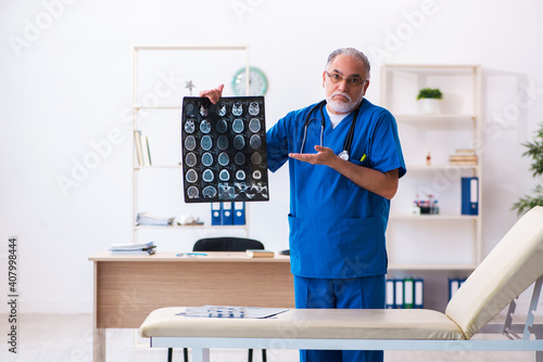 Old male doctor radiologist working in the hospital