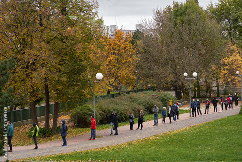 Bratislava,  Slovakia, October 31, 2020: People waiting in a line for a Covid-19 antigen test. Nationwide testing of the Slovak population for coronavirus COVID-19.  © balcoimages