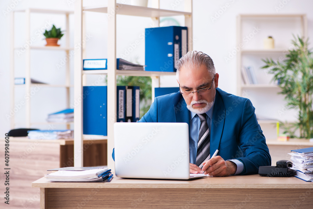 Old male bookkeeper unhappy with excessive work at workplace Old male bookkeeper unhappy with excessive work at workplace