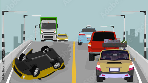 Passenger car accident overturned on a different level bridge. Car jams accumulate on the road a lot. Big city silhouette as background and daytime sky.