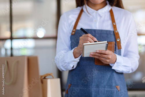 Closeup image of a female entrepreneur checking orders from customer