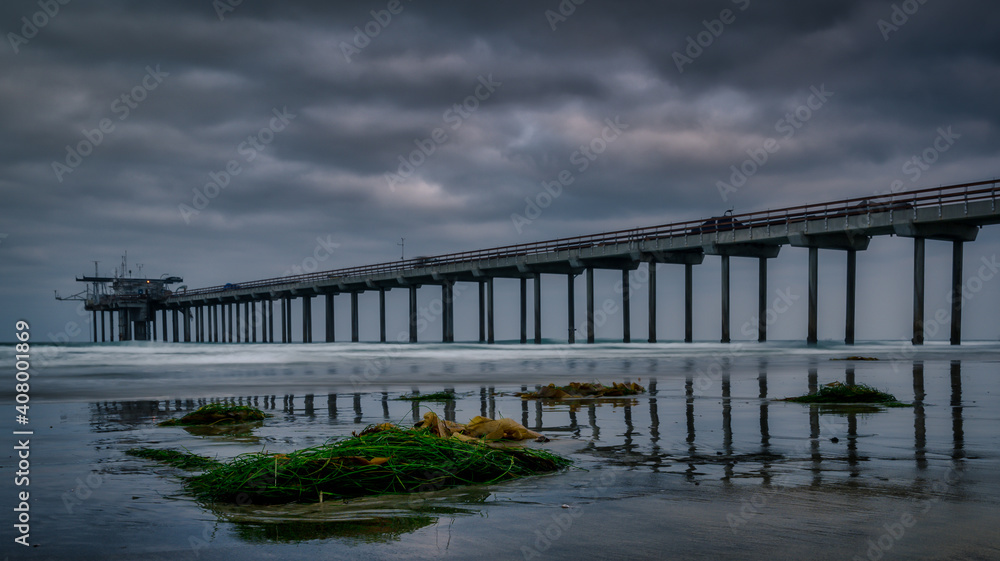 Scripps Memorial Pier early morning reflecting in wet sand