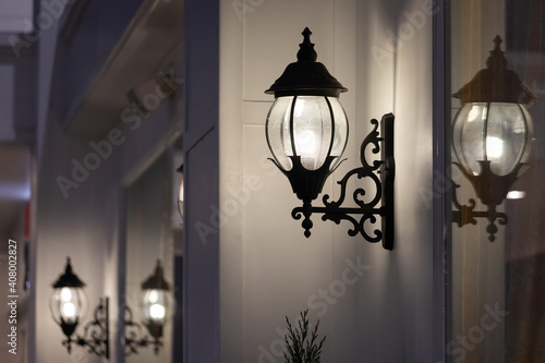 wrought-iron wall lamp of outdoor building at night time.