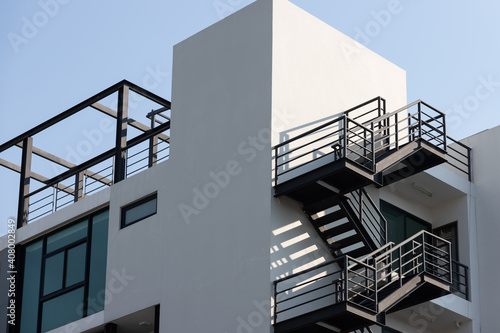 Fototapet fire escape stair steel. black outdoor metal stair of building.