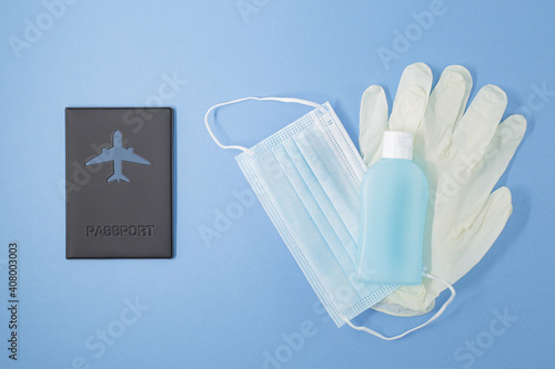 Passport on Flat layer. Planning a trip kit. Medical gloves mask and Antibacterial  Alcohol Sanitaizer for protecting from infection virus during Coronavirus covid pandemic. photo