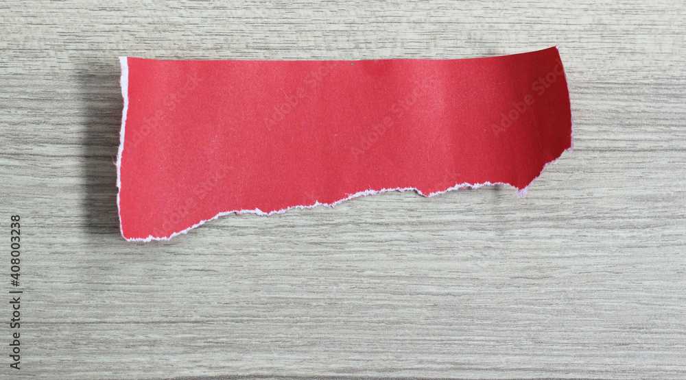 pieces of torn red paper texture on wood background with copy space for text pieces of torn red paper texture on wood background with copy space for text