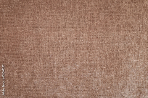 The texture of coarse brown fabric is used for upholstery of rustic furniture.