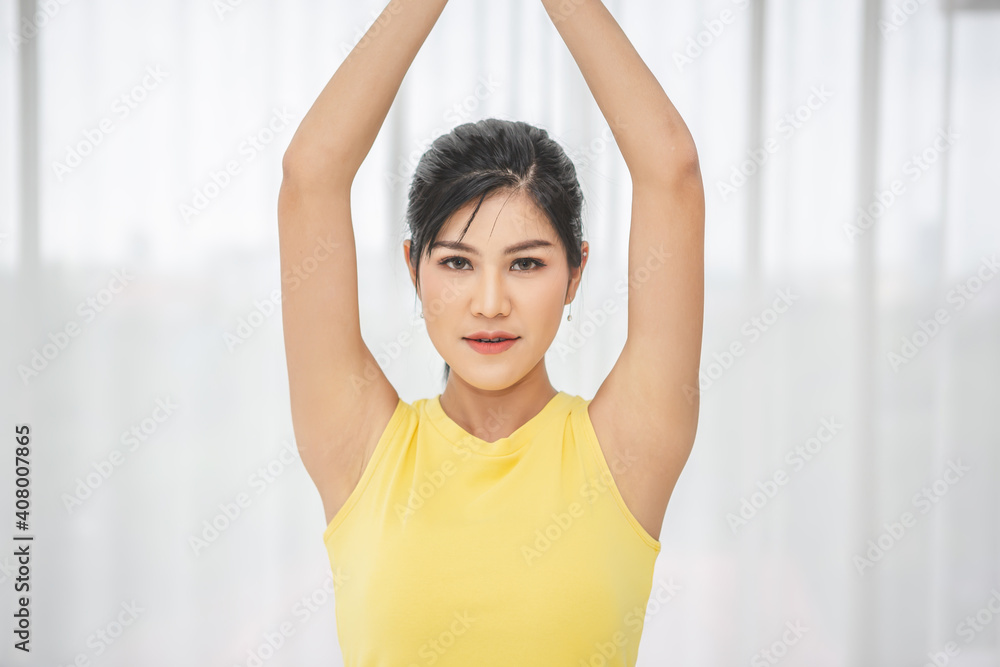 Young beautiful Asian woman exercising in her bedroom in the morning Young beautiful Asian woman exercising in her bedroom in the morning