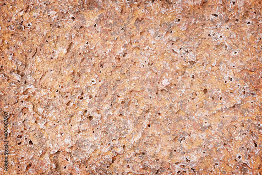 Red rock or red stone background and texture with rough holes Red rock or red stone background and texture with rough holes