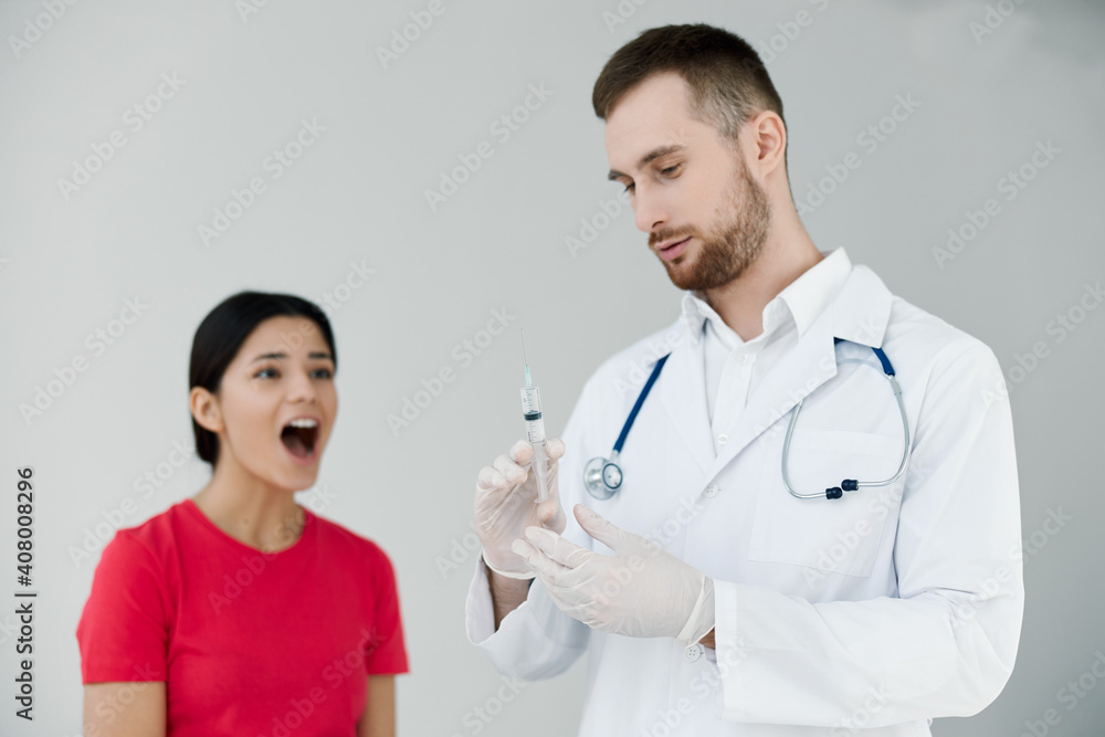 woman with open mouth is afraid of injections near the doctor covid vaccination woman with open mouth is afraid of injections near the doctor covid vaccination
