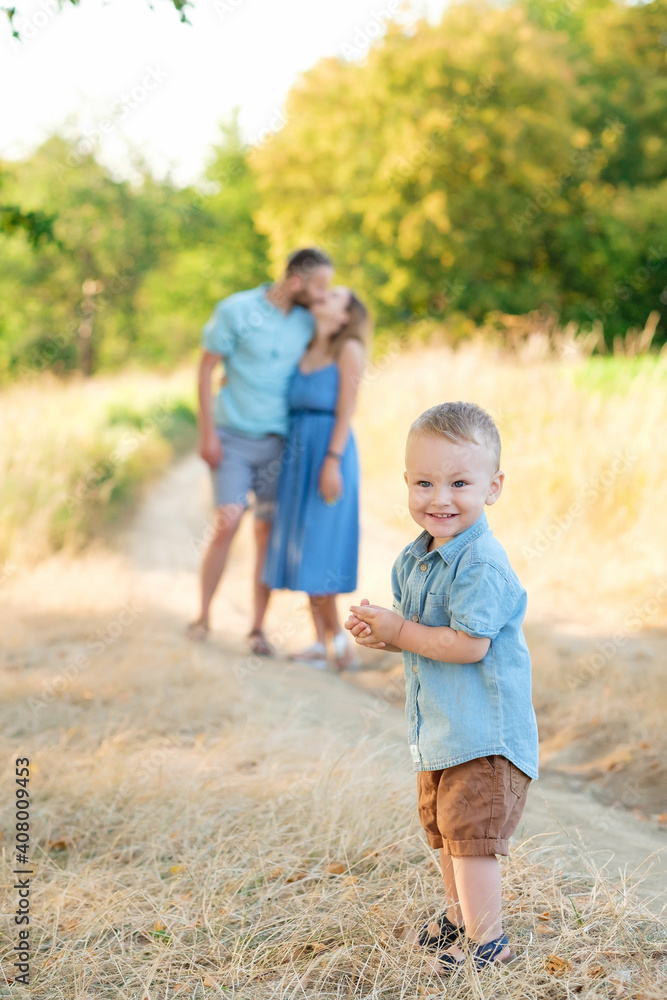 Family life. Little baby boy with parents on the background of nature. Walk in park. Happy family leisure outdoors. Family life. Little baby boy with parents on the background of nature. Walk in park. Happy family leisure outdoors.