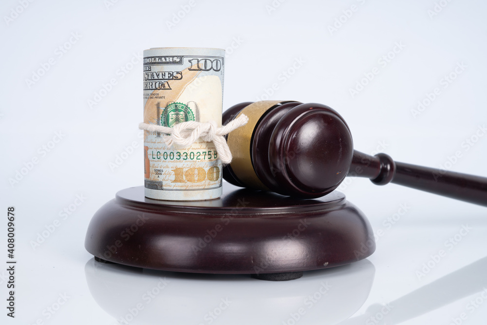 Gavel hammer and banknotes with white background.