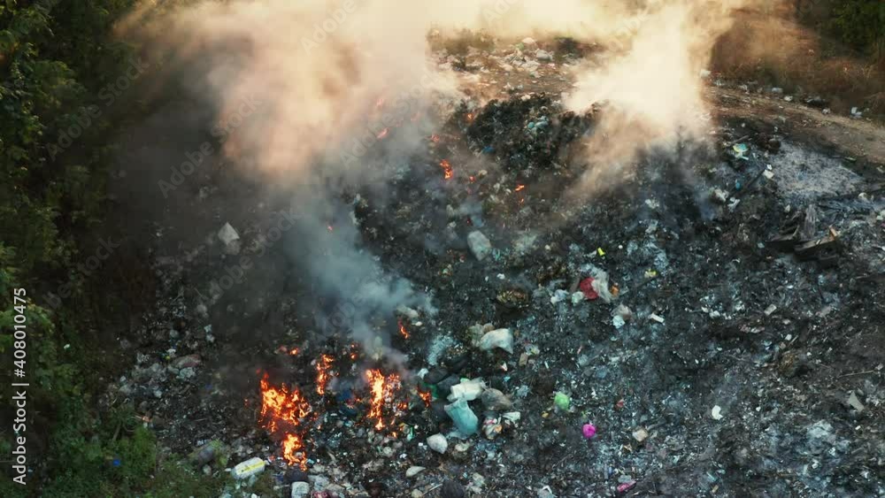 Garbage and fire burn in landfill. Also call trash, waste, rubbish. Destruction with combustion, heat, flame. Occurs smoke, toxic cause of air pollution, environmental damage and global warming. Garbage and fire burn in landfill. Also call trash, waste, rubbish. Destruction with combustion, heat, flame. Occurs smoke, toxic cause of air pollution, environmental damage and global warming.