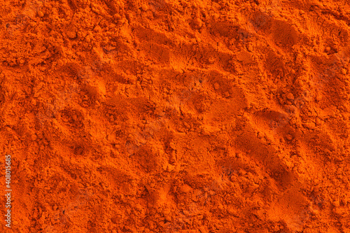 Full frame of red ground paprika background texture