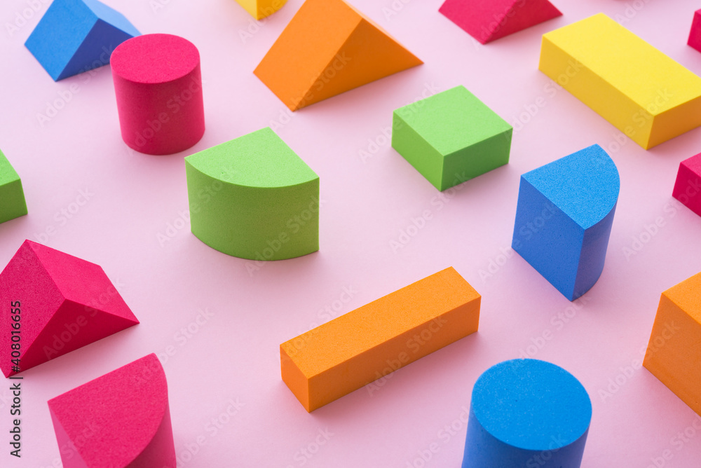 Obraz premium Set of colorful geometric cube or block toy on pink background. Abstract pattern design composition by shape and form. Education, business solution and creative design product concept.