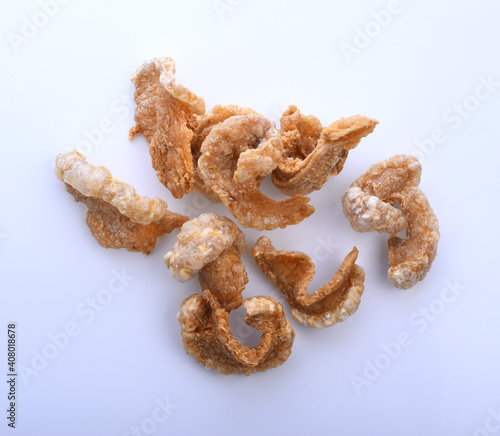 Pork snack or Pork rind leather lean pork fried crispy and blistered isoloated on white background. Thai food, Close-up photo