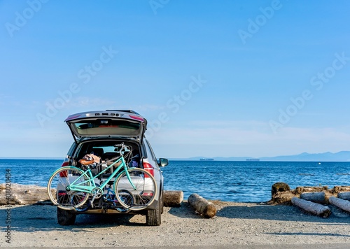 Car with bikes on the beach