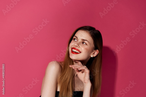 Cute cheerful woman and red lips cosmetics emotions pink background