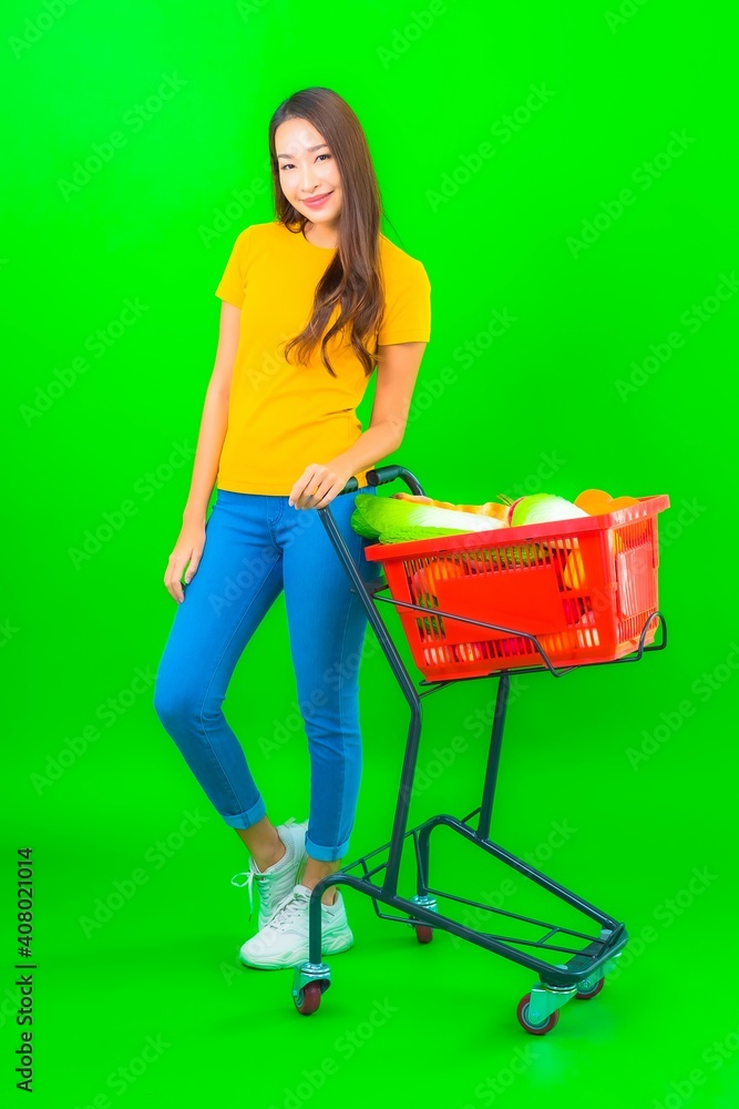 Portrait beautiful young asian woman with grocery basket and cart from supermarket