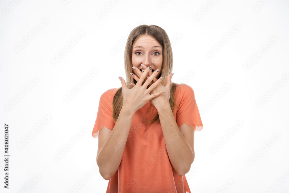 Worried blond girlcover opened mouth palms and looking with surprised expression. Studio shot, white background Worried blond girlcover opened mouth palms and looking with surprised expression. Studio shot, white background