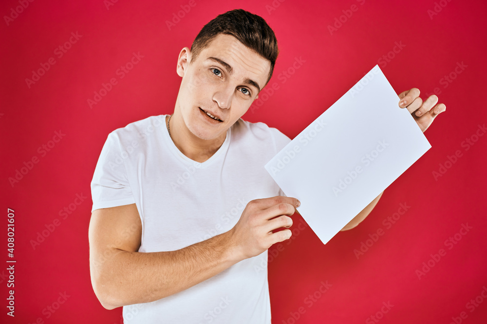man holding white sheet copy space office close-up red background man holding white sheet copy space office close-up red background