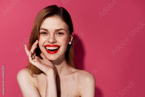 Cute cheerful woman and red lips cosmetics emotions pink background