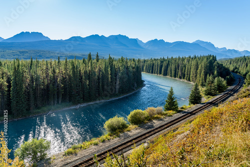 Bow River flows through forest and railway track. Storm Mountain in the background. Castle Cliff Viewpoint, Bow Valley Parkway, Banff National Park, Canadian Rockies, Alberta, Canada.