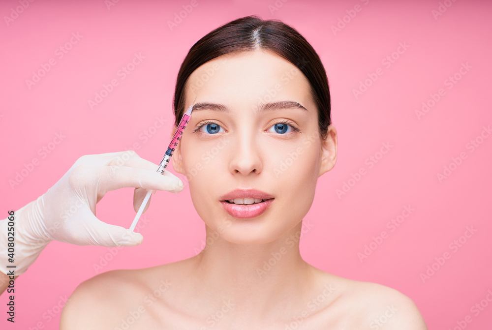 Portrait of a young attractive girl during cosmetic procedures on the face.