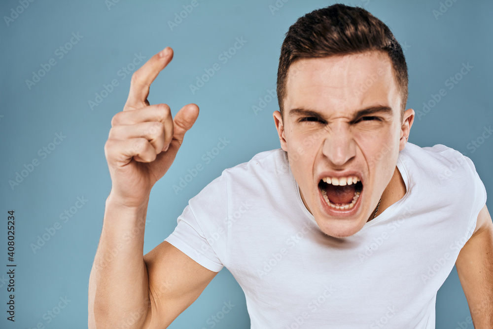 Man gestures with his hands emotions white t-shirt expression blue background Man gestures with his hands emotions white t-shirt expression blue background
