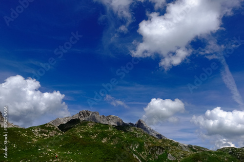 white clouds on a blue sky in the mountains