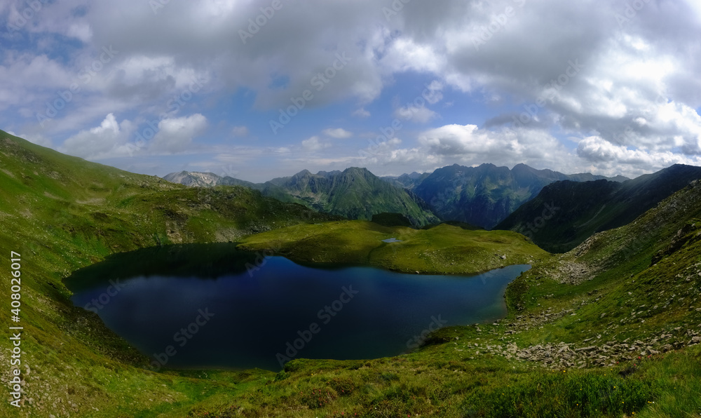 wonderful deep blue mountain lake in a green valley in the mountains panorama