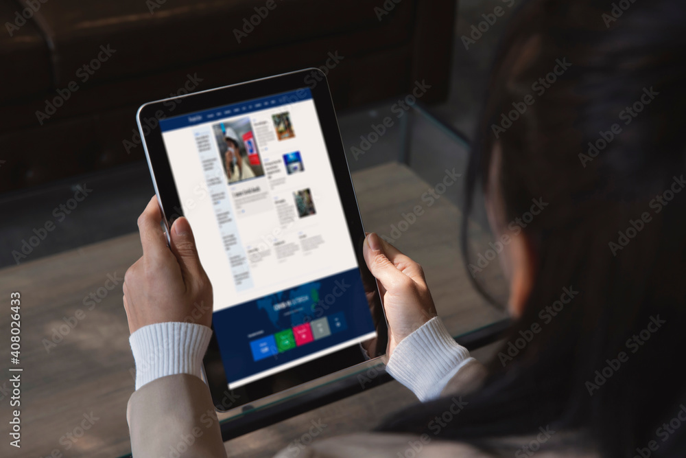 Closeup businesswoman reading news or articles on website on the screen in smart taplet , internet networking concept Closeup businesswoman reading news or articles on website on the screen in smart taplet , internet networking concept