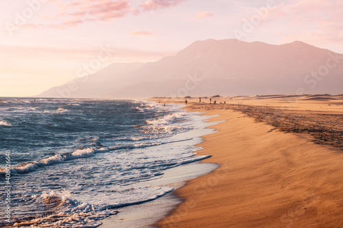 Fototapeta Naklejka Na Ścianę i Meble -  Sunset view of the Mediterranean coast near Patara beach in Turkey. High mesmerizing mountains in the background. Hidden natural treasures