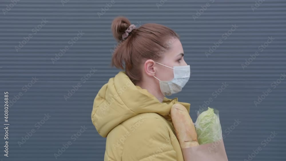 Young woman with purchases from the supermarket. Masked woman with purchases from the store. High quality 4k footage Young woman with purchases from the supermarket. Masked woman with purchases from the store. High quality 4k footage