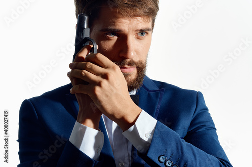 man in suit holding a gun detective crime isolated background