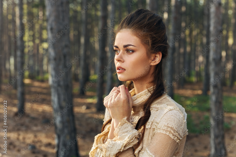 Woman in dress in the forest beautiful hairstyle Vintage fairy witch model Woman in dress in the forest beautiful hairstyle Vintage fairy witch model