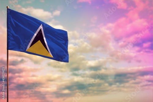 Fluttering Saint Lucia flag mockup with the space for your content on colorful cloudy sky background.