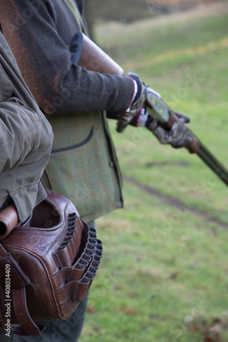 'Loader' and 'Gun' holding a 12 bore shotgun on a pheasant shoot in the rural Oxfordshire countryside.