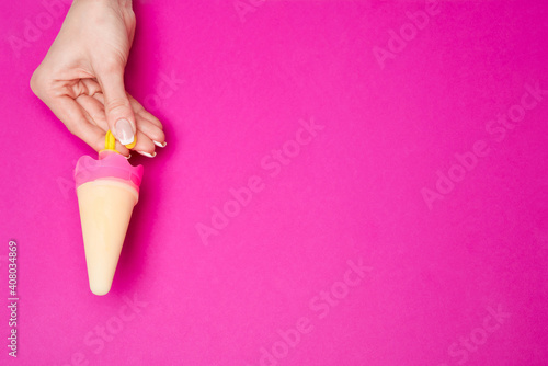 Beautiful Female well-groomed Hands with French manicure over pink background